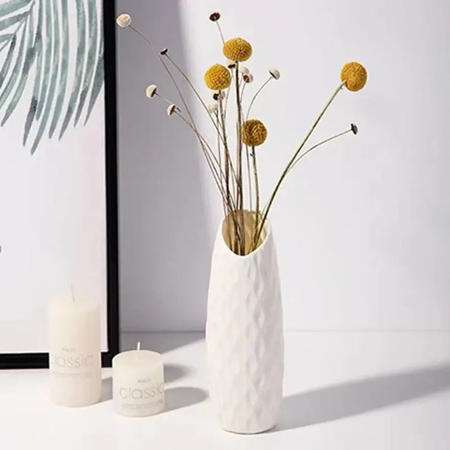 DecorBites™ plastic vase imitation ceramic with white textured finish holding dried yellow and white spherical flowers