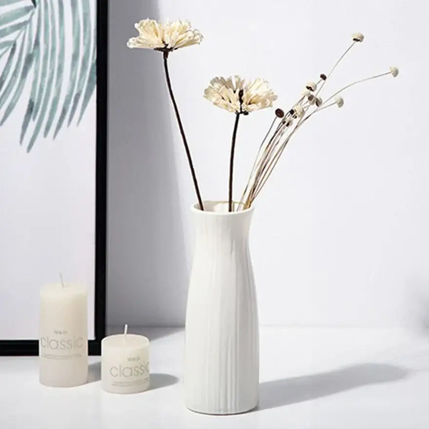 Decorbites™ ceramic-look plastic vase imitation with white vertical ribbed texture holding dried cream flowers