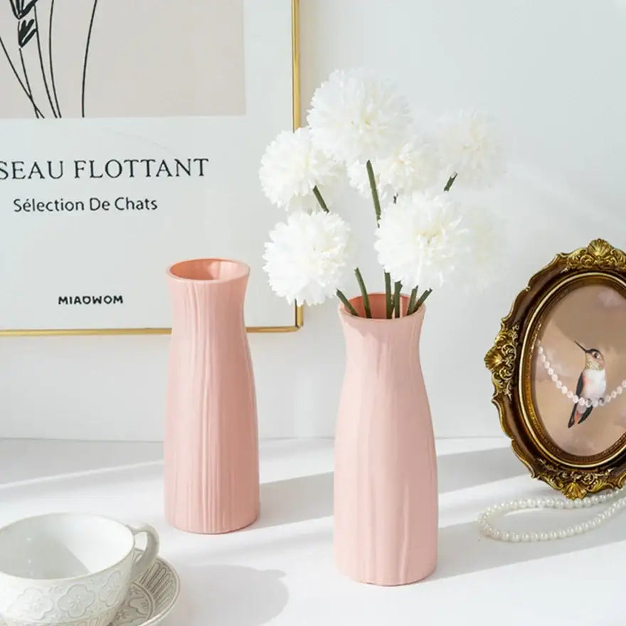 Two blush pink decorbites™ ceramic-look plastic flower pots with vertical ribbed texture in vase imitation design