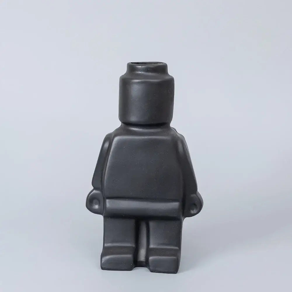 Black ceramic robot vase shaped like a lego minifigure for nordic style home decor by DecorBites