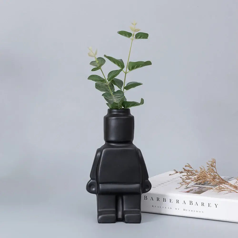 Black ceramic robot vase decorbites with nordic style smooth matte finish shaped like a stylized humanoid figure