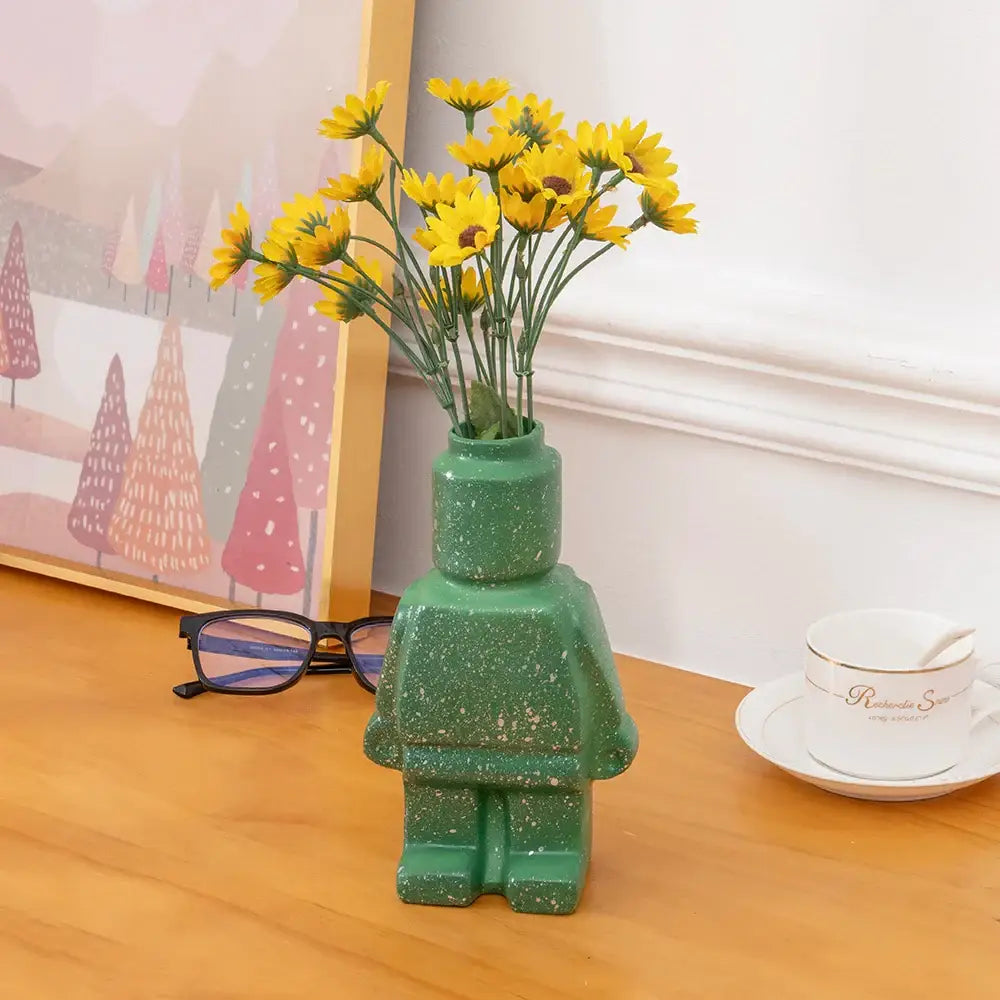 Green speckled ceramic robot vase shaped like a lego minifigure for nordic style home decor by decorbites