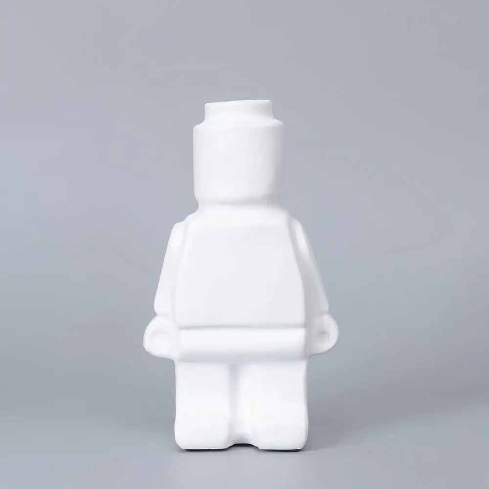 White ceramic robot vase shaped like a lego minifigure designed for nordic style home decor by decorbites
