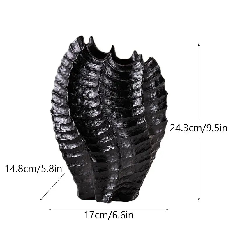 Black glossy resin sculpture shaped like a segmented insect exoskeleton featured with decorbites ceramic sea vase nordic modern decor