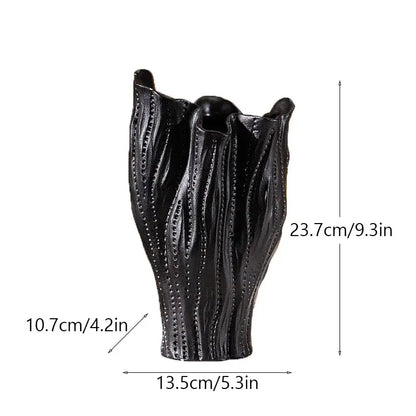 Black ceramic sea vase with textured leaf design and vertical dotted patterns in nordic modern decor style