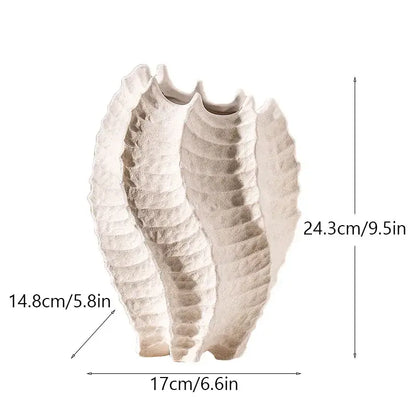 Cream-colored textured ceramic sea vase with sculpted shell-like design for nordic modern decor by DecorBites