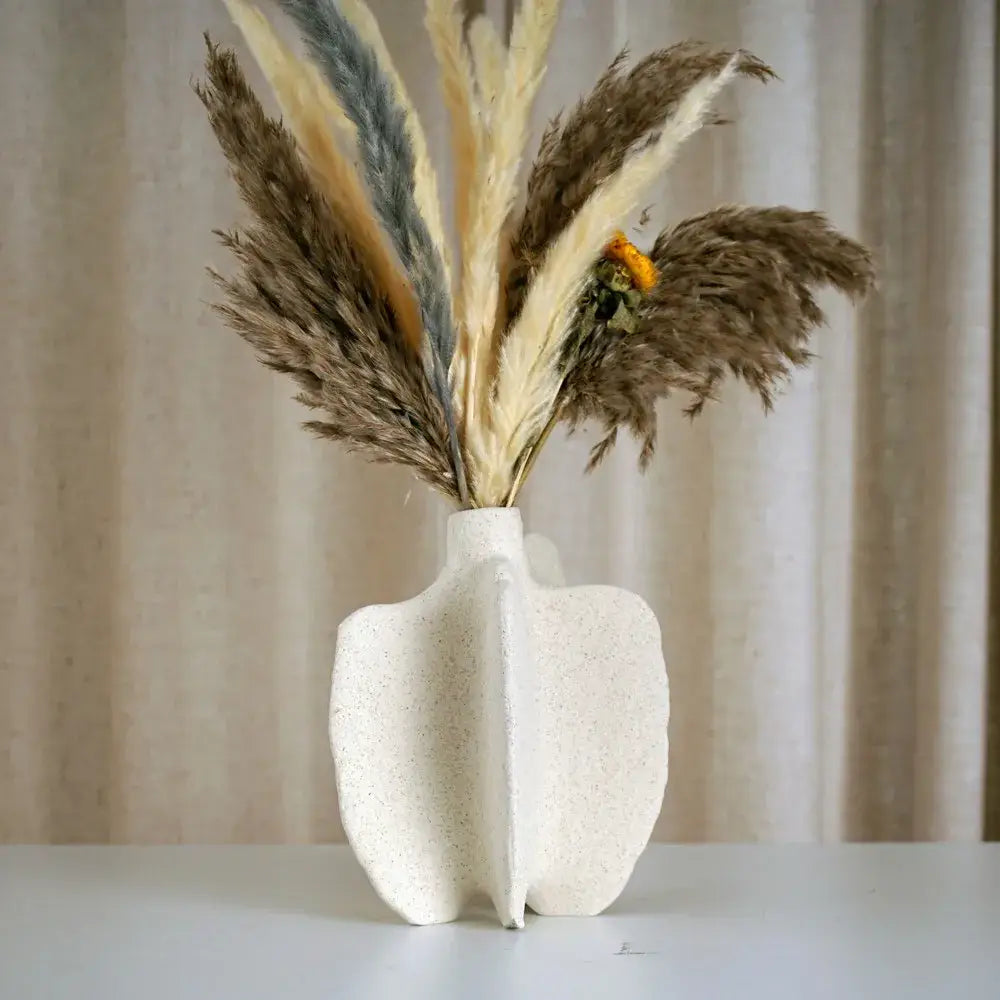 DecorBites™ ceramic sea vase is a white textured ceramic sea vase with nordic modern design holding dried pampas grass