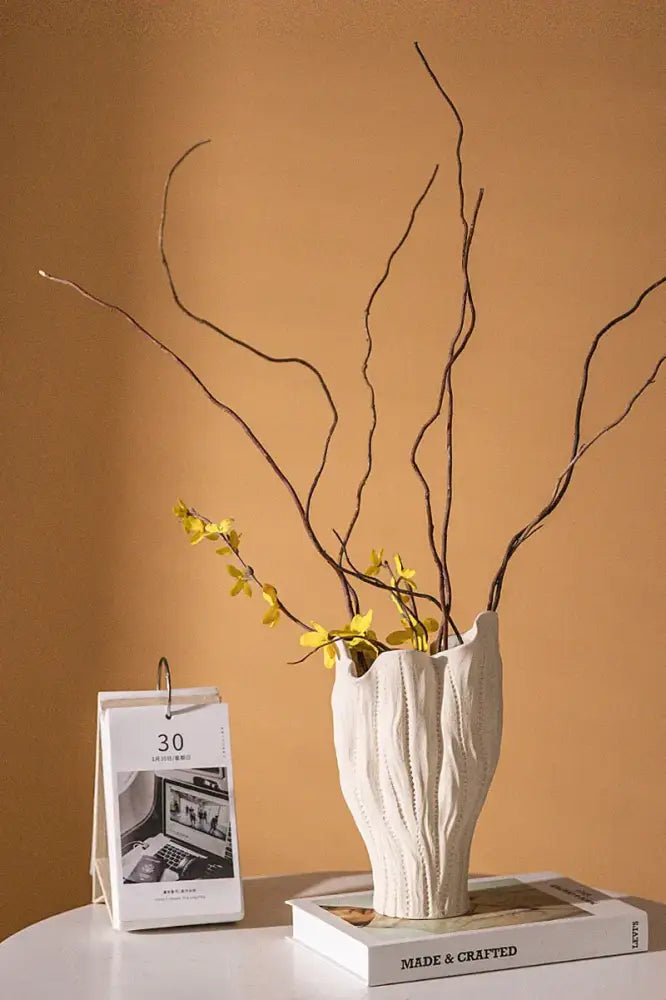 White ceramic sea vase with vertical ridged texture and organic flared shape in nordic modern decor style