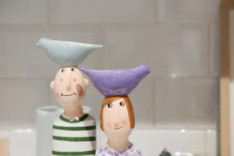 DecorBites™ ceramic vase set with man and woman figurines balancing bird-shaped bowls in blue and purple for home decor