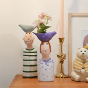 Decorbites™ ceramic vase set featuring two stylized ceramic vases in light blue and purple for home decor