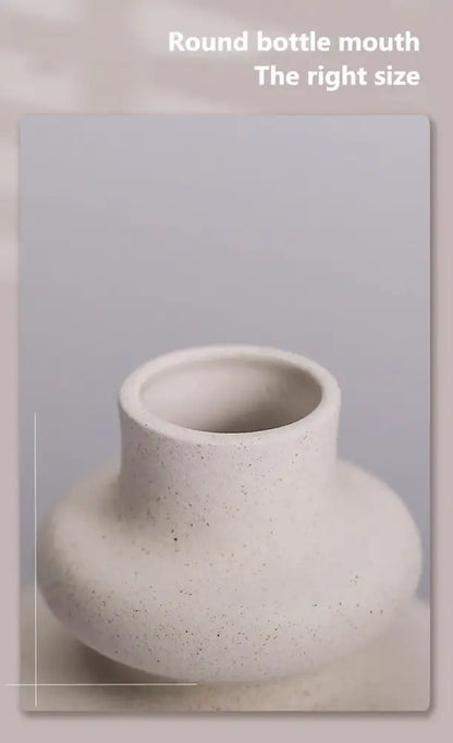 Cream-colored speckled ceramic vase with rounded bottle mouth from DecorBites™ ceramic vases for modern home decor