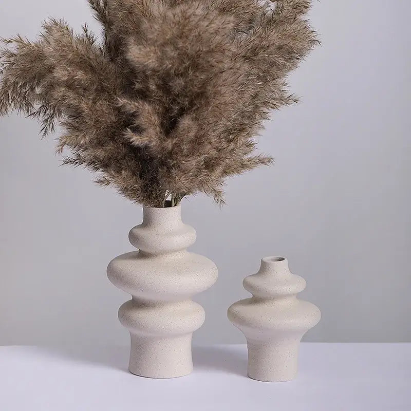 Cream-colored ceramic vases with stacked rounded segments and textured surface for modern home decor by decorbites