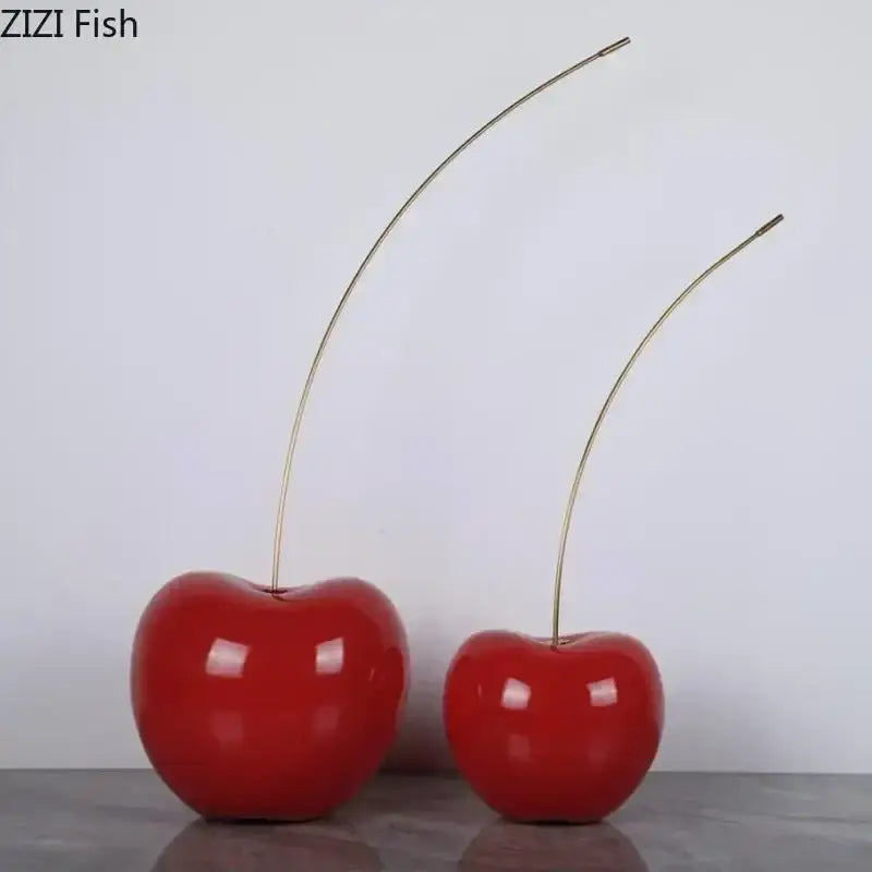 Two glossy red cherry fruit sculpture ornaments with slender golden stems for modern home decoration by DecorBites