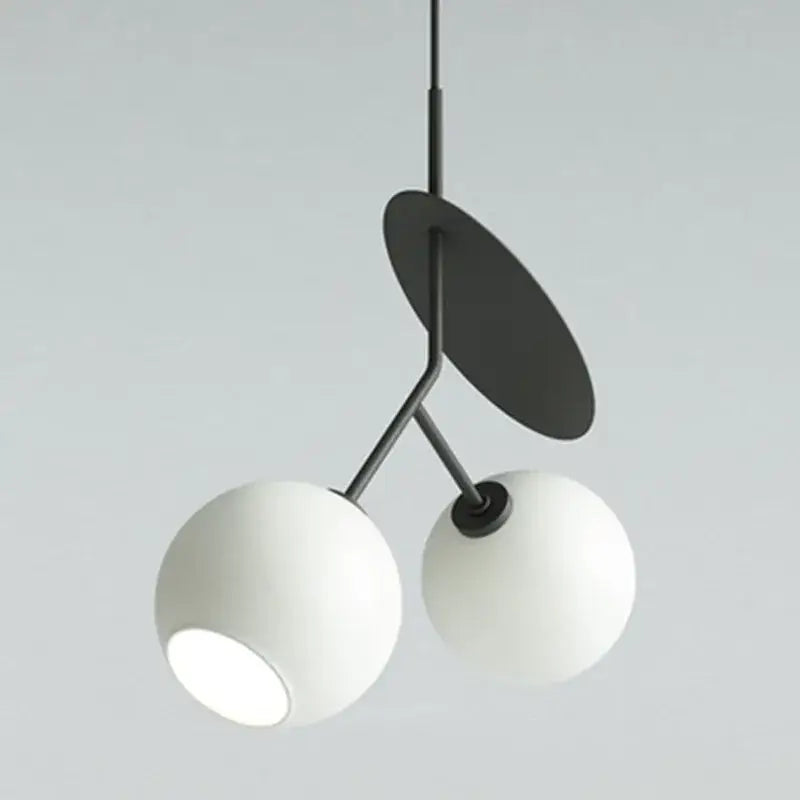 Modern black metal pendant lights with two white spherical glass shades from DecorBites cherry glass pendant collection