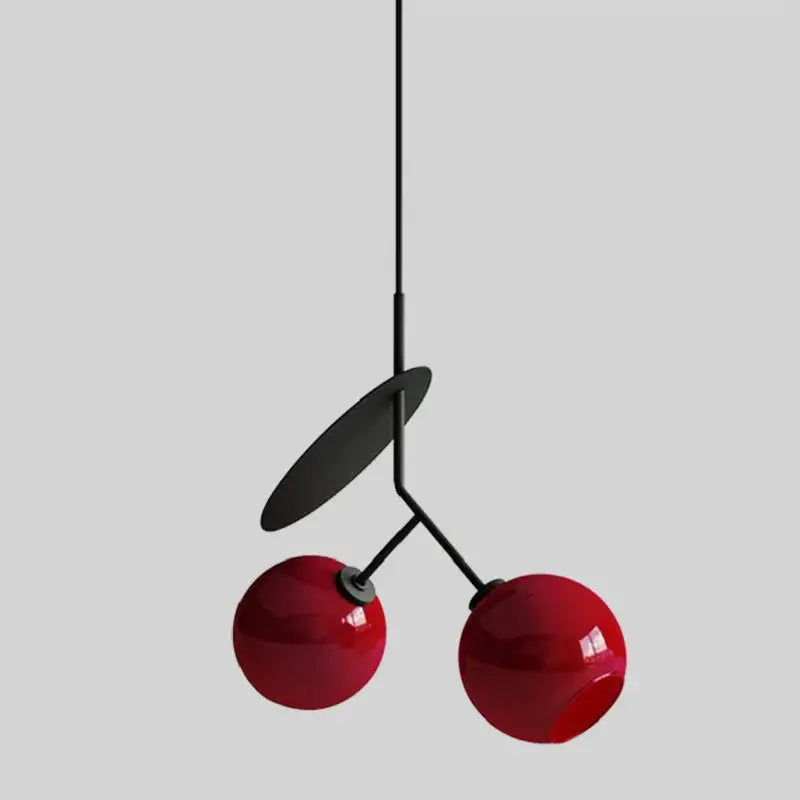Red glossy spherical decorbites cherry glass pendant light with black metal stem and leaf accent for home decor lighting