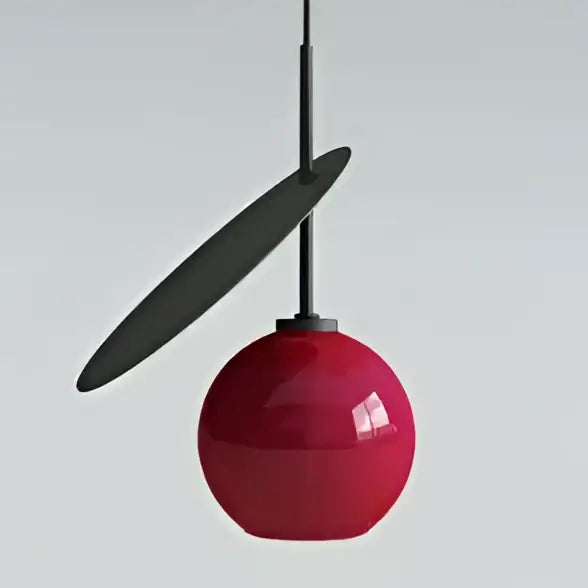 A sleek glossy red decorbites cherry glass pendant light with matte black disc accent for home lighting