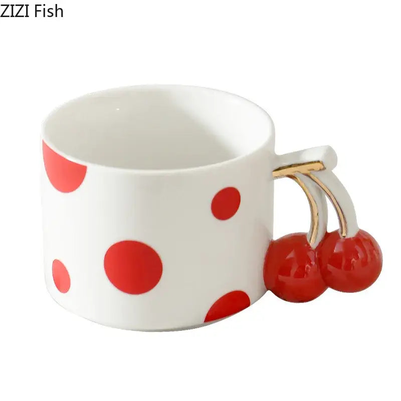 White ceramic coffee mug with red polka dots and a decorbites cherry handle gold plated porcelain design
