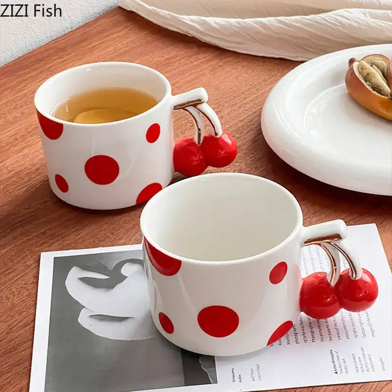 White ceramic coffee mug with red polka dots and a cherry handle gold design by DecorBites cherry handle porcelain