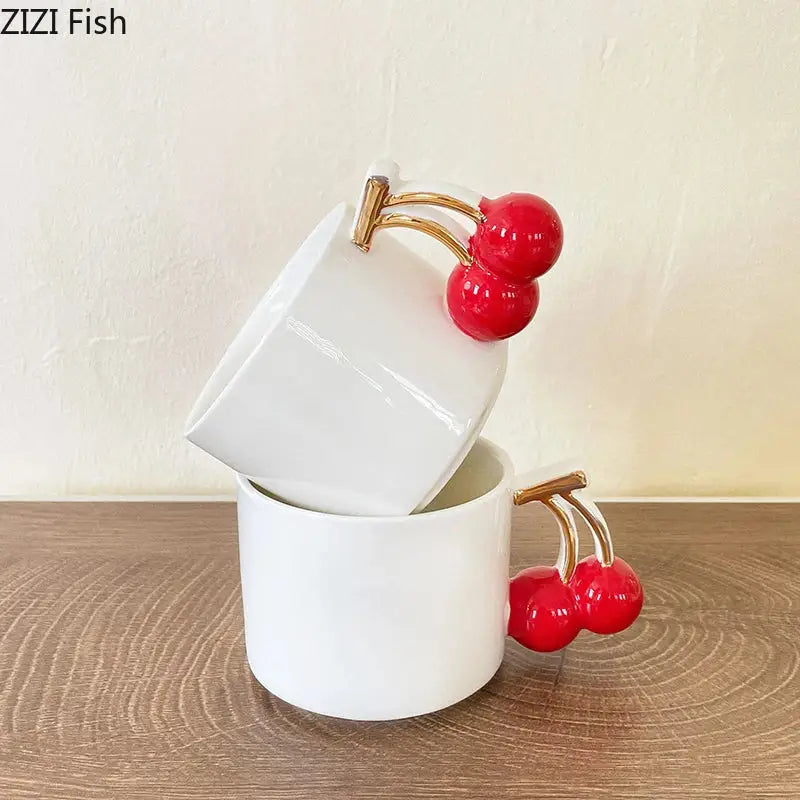 White ceramic tea cup with a glossy finish featuring a red cherry handle mug by DecorBites for dining table use