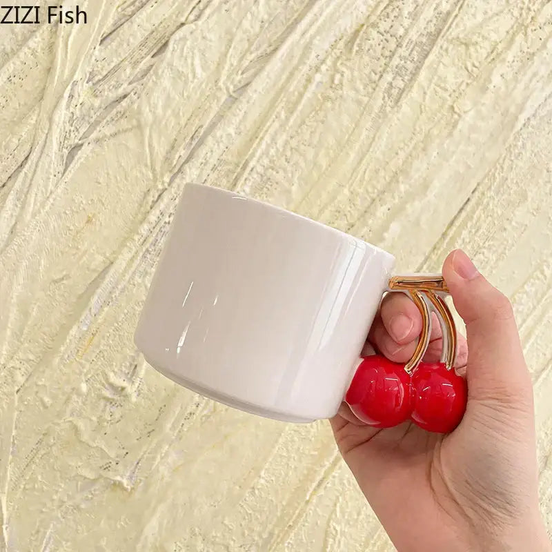Decorbites™ cherry handle mug is a white ceramic tea and coffee cup with a playful cherry handle and gold-toned stems