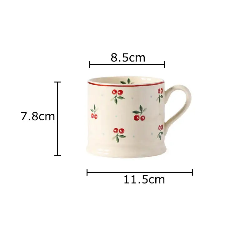 Cream-colored DecorBites cherry pattern porcelain coffee mug with red cherries green leaves and a thin red rim for afternoon tea