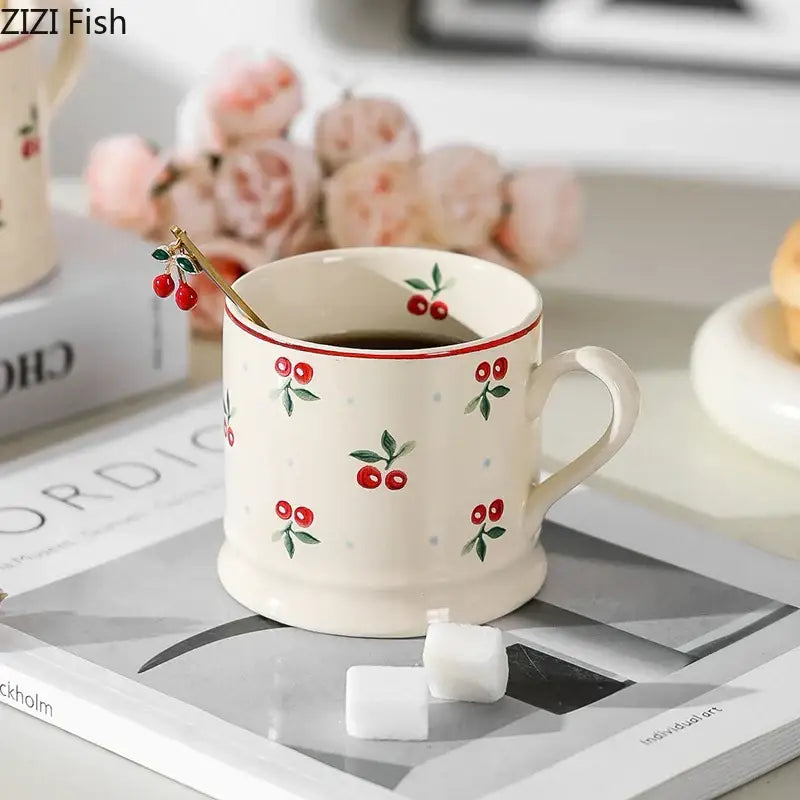 Cream-colored creamBites™ cherry pattern porcelain coffee mug with lovely cherry decals and gold-toned spoon inside