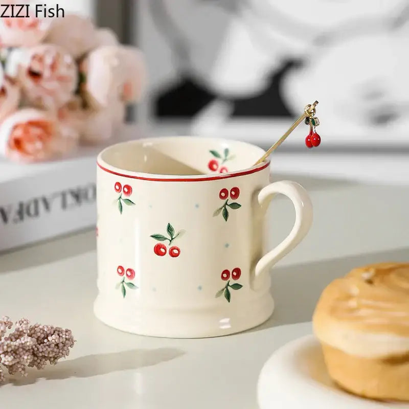 Cream-colored lovely cherry pattern porcelain coffee mug with red cherries rim and matching spoon for afternoon tea