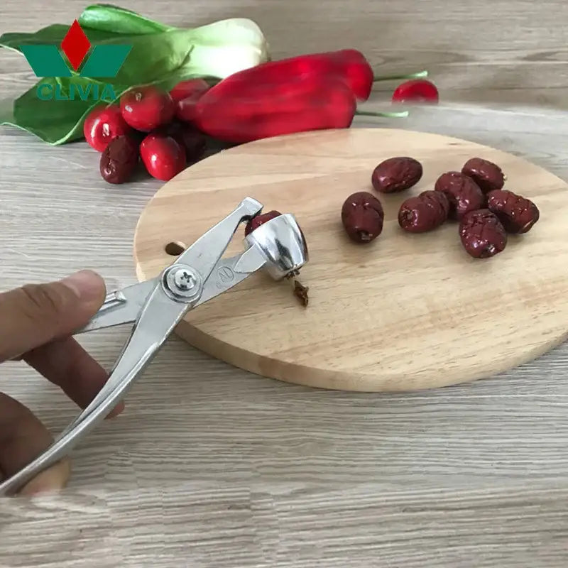 Silver metal nutcracker with polished finish for cracking hard-shelled fruits in decorbites cherry pitter tool
