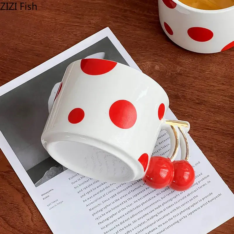 White ceramic decorbites cherry porcelain mug with bold red polka dots and gold plated cherry-shaped handle