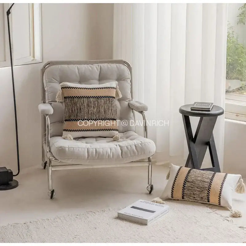 A beige tufted armchair with metal frame and wheels featuring a decorbites chestnut brown wabi pillow case with heavy texture