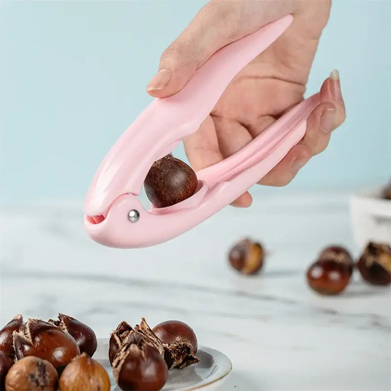 Pink plastic decorbites chestnut cracker with small silver screw detail for cracking nuts and shells