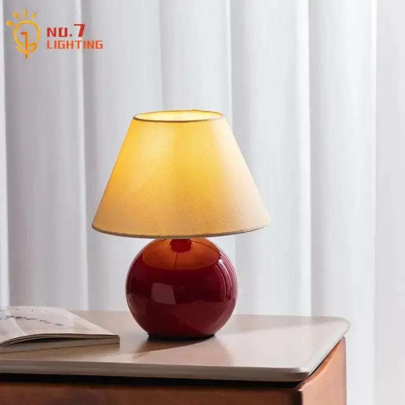 DecorBites chestnut glass table lamp with a glossy deep red ceramic base and beige fabric tapered shade for living room