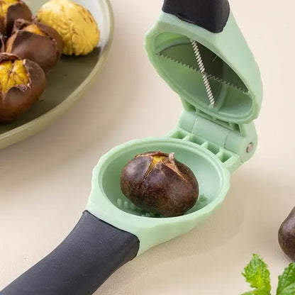 Light green plastic nut cracker with black grip and serrated blade in the DecorBites chestnut machine nut cracker set