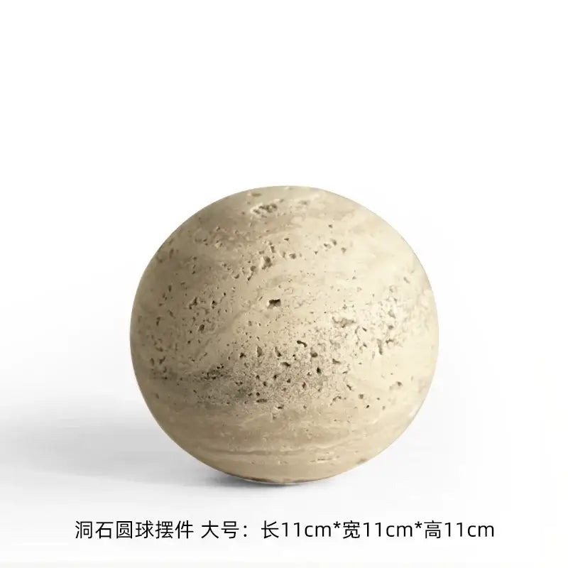 Beige concrete sphere decorative ornament with a textured porous surface featuring subtle natural imperfections for wabi sabi wind decor