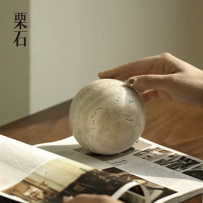 A matte off-white textured ceramic sphere with subtle imperfections in the decorbites wabi sabi wind ornament collection