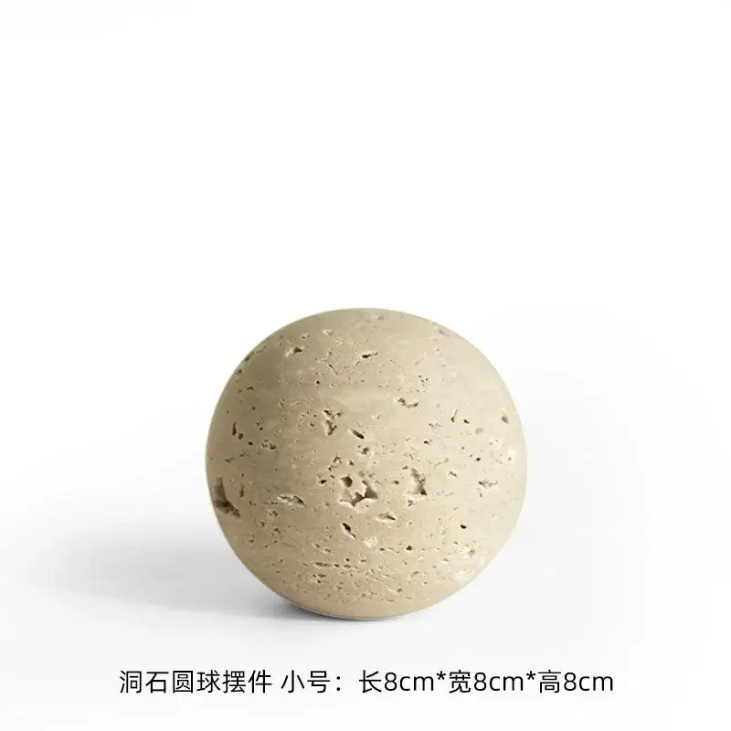 Beige porous stone sphere with textured surface and small holes in decorbites wabi sabi wind geometric rock ornament