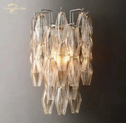 DecorBites™ Chiara glass LED wall sconce with a metallic frame and cascading translucent glass shades catching light