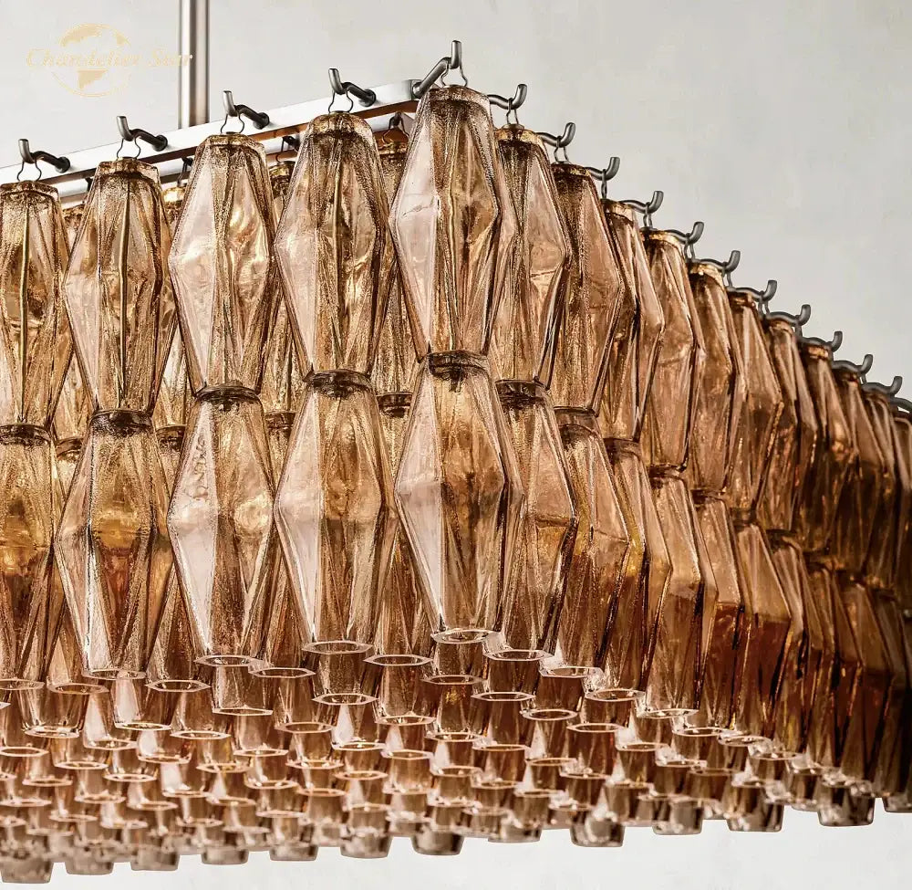 A modern DecorBites Chiara smoke linear chandelier with amber faceted glass tiers for dining and living rooms