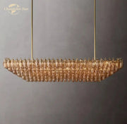 Gold-toned decorbites chiara smoke glass tiered chandelier with modern elongated design and faceted amber glass pieces