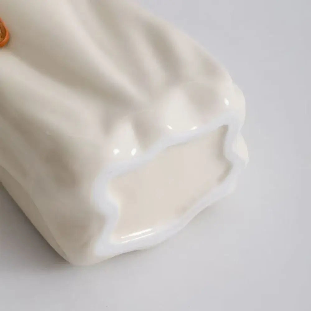 Cream-colored chic ceramic vase from decorbites™ with glossy finish and soft ruffled texture for home decoration