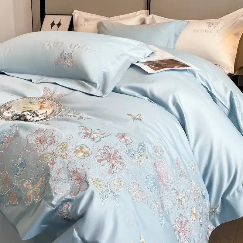 Light blue satin duvet cover with delicate butterfly and floral embroidery in decorbites chic embroidered cotton bedding set