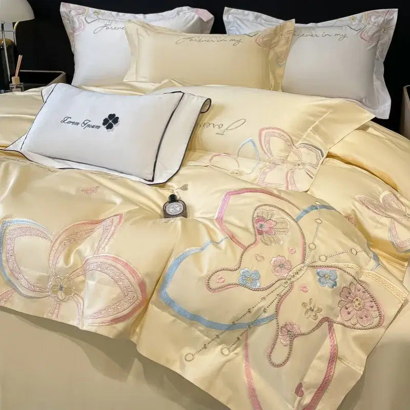 Cream-colored satin decorbites chic embroidered bedding set with intricate butterflies and floral patterns in pastel hues
