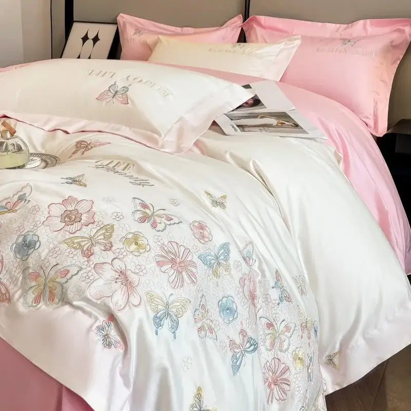 White satin bedding set with delicate embroidered butterflies and flowers in pastel hues from decorbites chic embroidered cotton collection