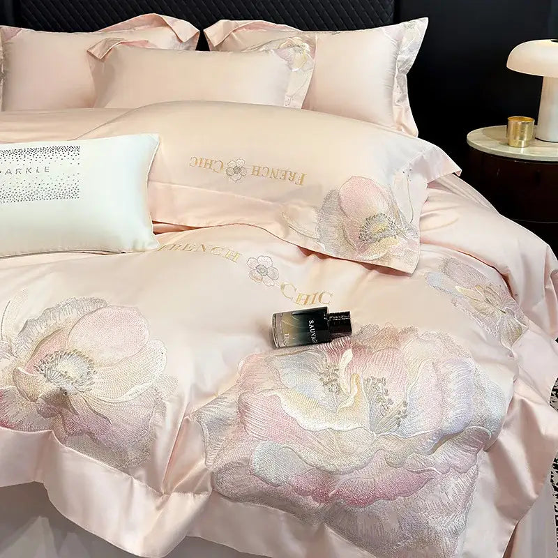 Pink satin bedding set with intricate floral embroidery and gold-threaded decorbites chic embroidered cotton lettering