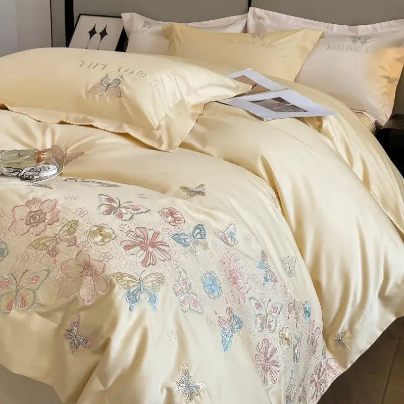 Cream-colored satin decorbites chic embroidered cotton bedding set with delicate pastel butterflies and flowers for luxury home décor