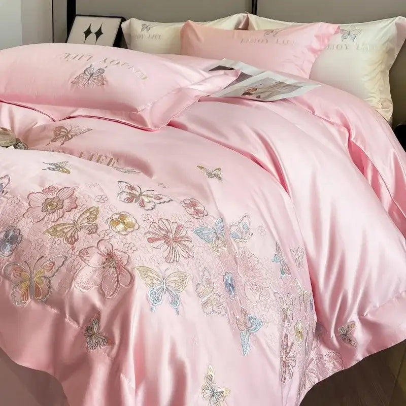 Pink satin duvet cover with delicate butterfly and floral embroidery in pastel hues from decorbites chic embroidered cotton bedding set