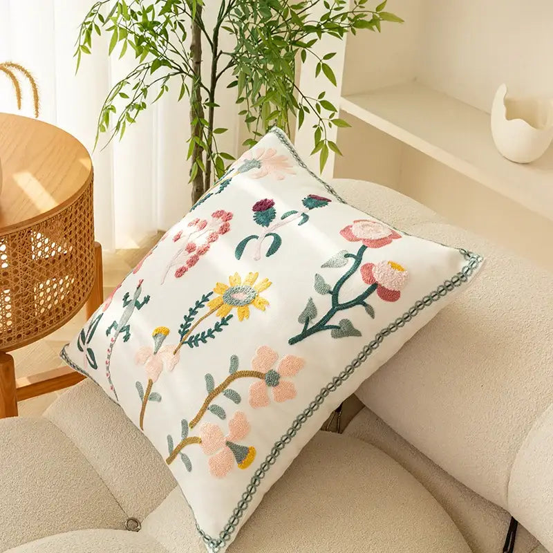 White cushion cover with intricate soft pink yellow and green floral embroidery from decorbites chic floral geometric collection 45x45cm