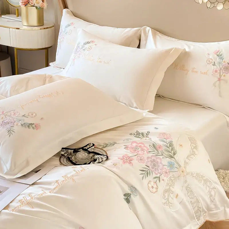 Cream-colored 100 percent cotton bedding set with delicate pink green floral embroidery and gold script accents by DecorBites™ Chic Flowers Embroidery