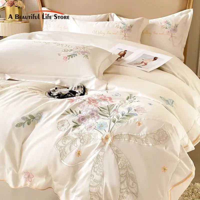 Cream-colored satin duvet cover with delicate floral embroidery and lace-trimmed bow from DecorBites chic flowers bedding set
