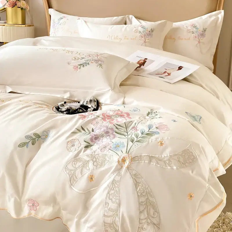 Cream-colored satin duvet cover with delicate floral embroidery and lace bow in decorbites chic flowers embroidery bedding set 100% cotton